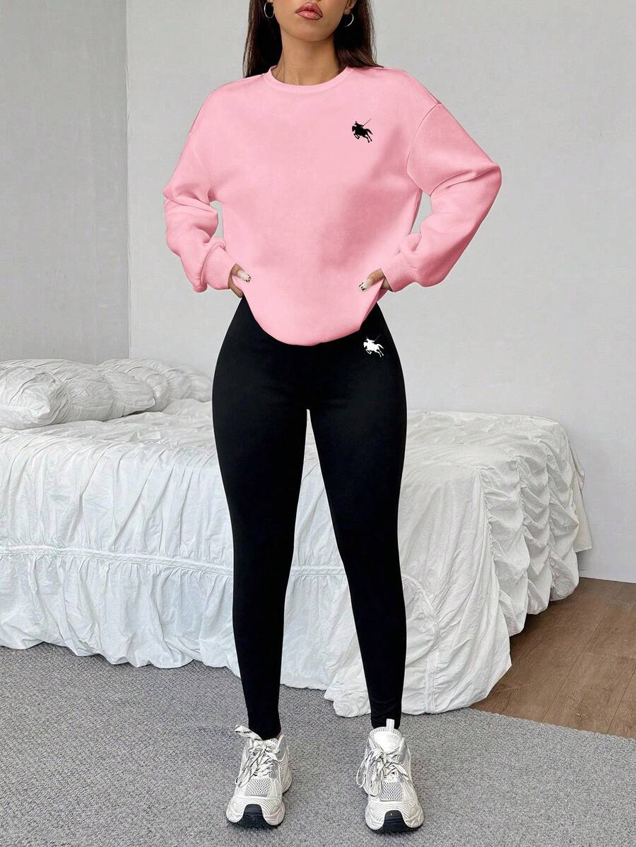 soft pink crew neck sweatshirt and black leggings set