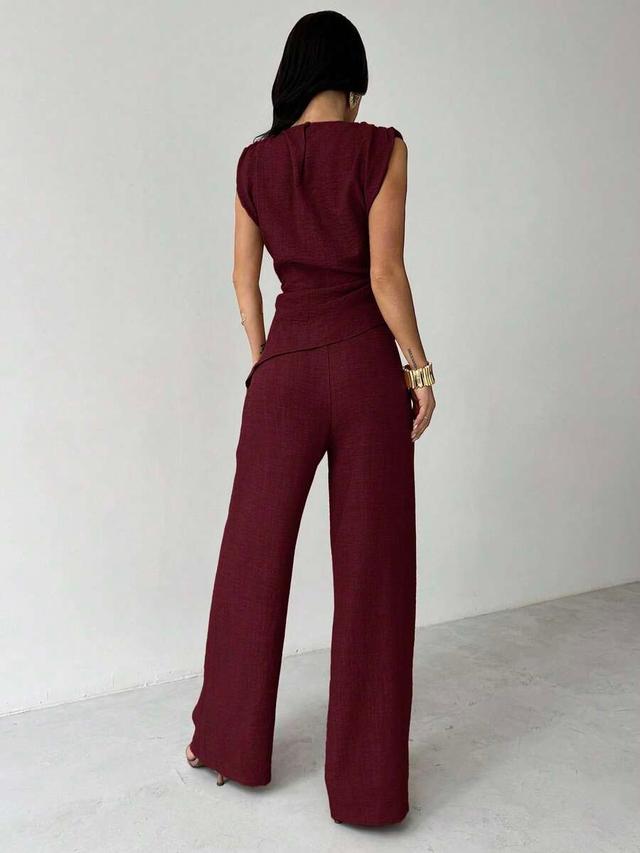 red wine sleeveless asymmetric ruched blouse and wide leg trousers