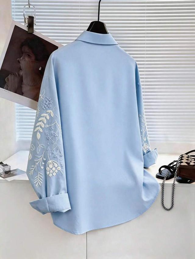 light blue floral embroidered collared button-up shirt