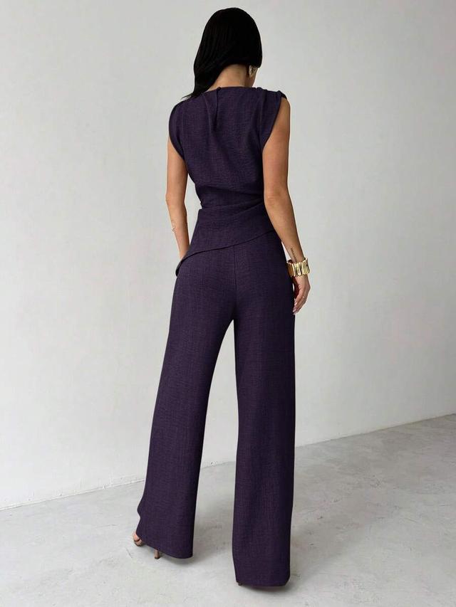 dark purple sleeveless ruched blouse and wide leg pants