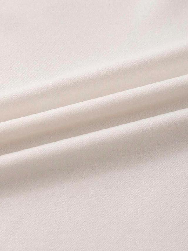 cream turtleneck vest and high-waisted trousers set