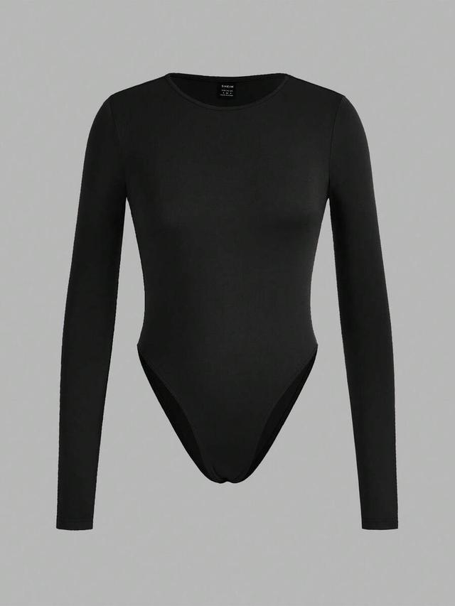 black three solid color long sleeve minimalist bodysuit