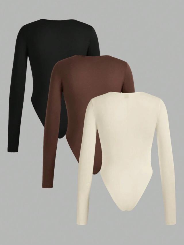 black three long sleeve round neck bodysuit in black brown and cream
