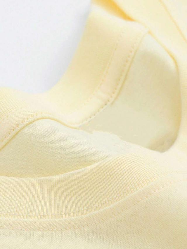 pale yellow oversized cotton crew neck t-shirt with graphic print
