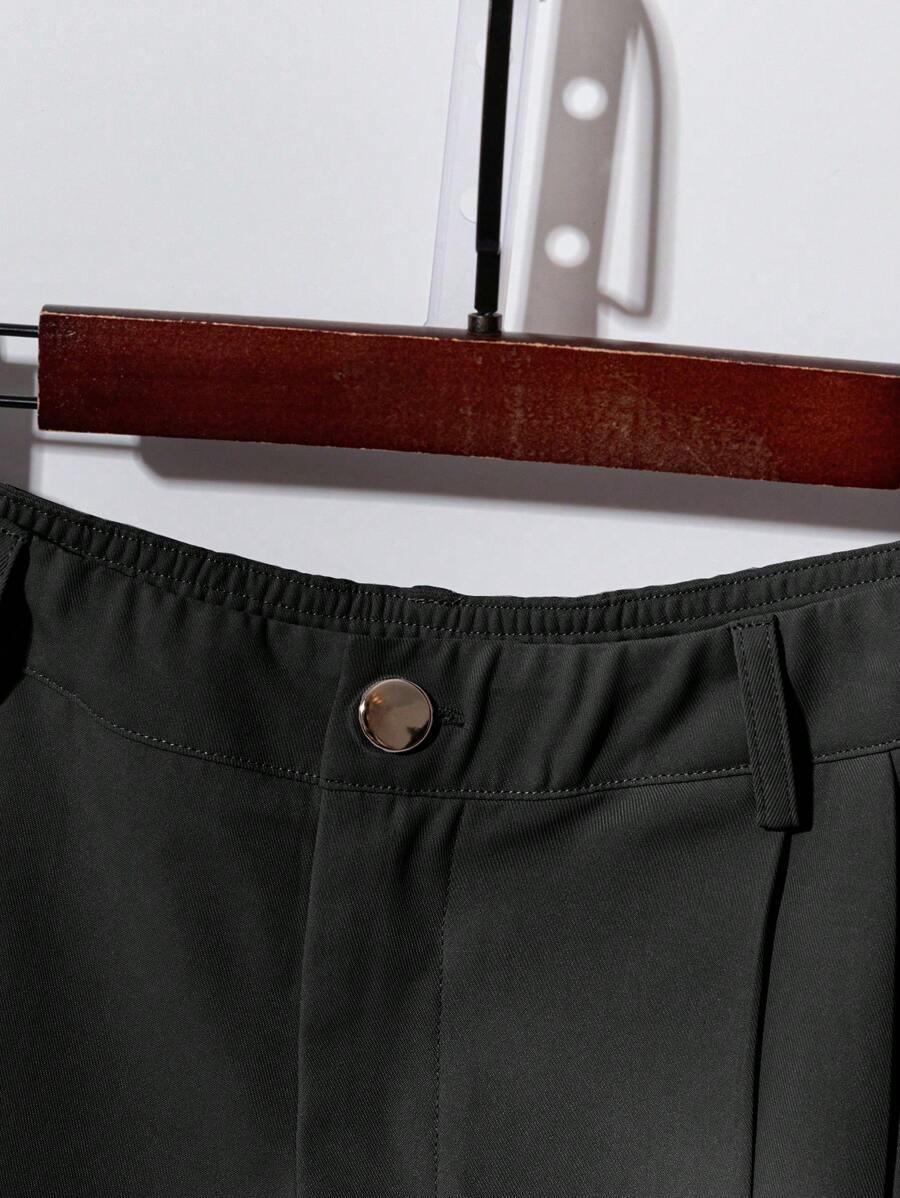 dark green short sleeve button-up shirt and pleated trousers