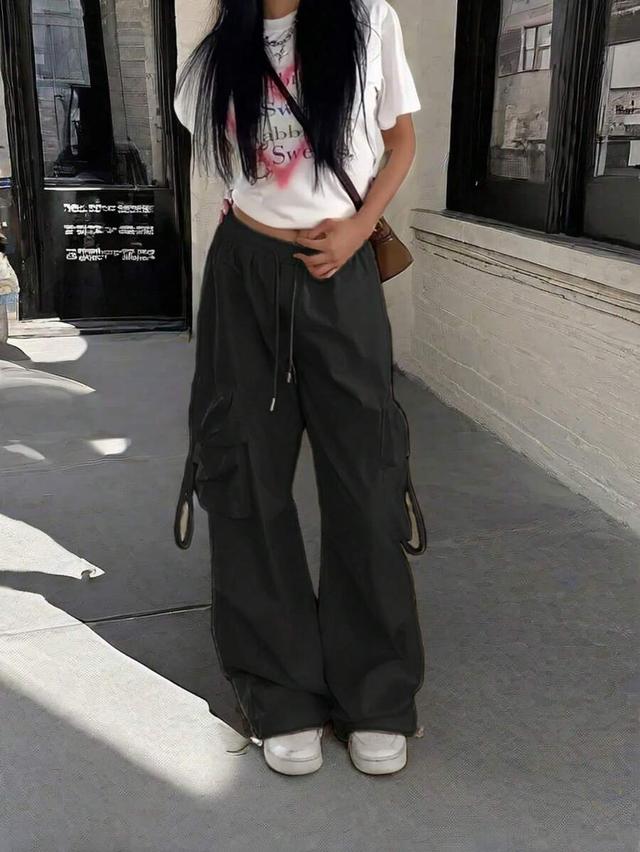 dark green high waist black parachute cargo pants with flap pockets