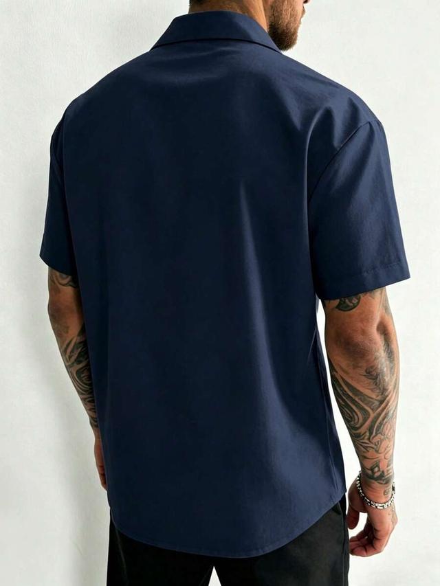 minimalist navy blue short sleeve button-up shirt