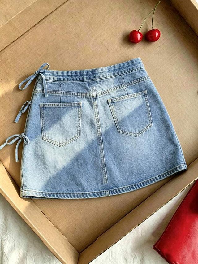 light wash faux denim mini skirt with side bows