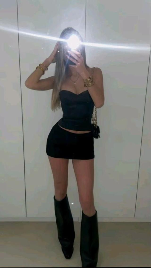 black corset top with matching black mini skirt