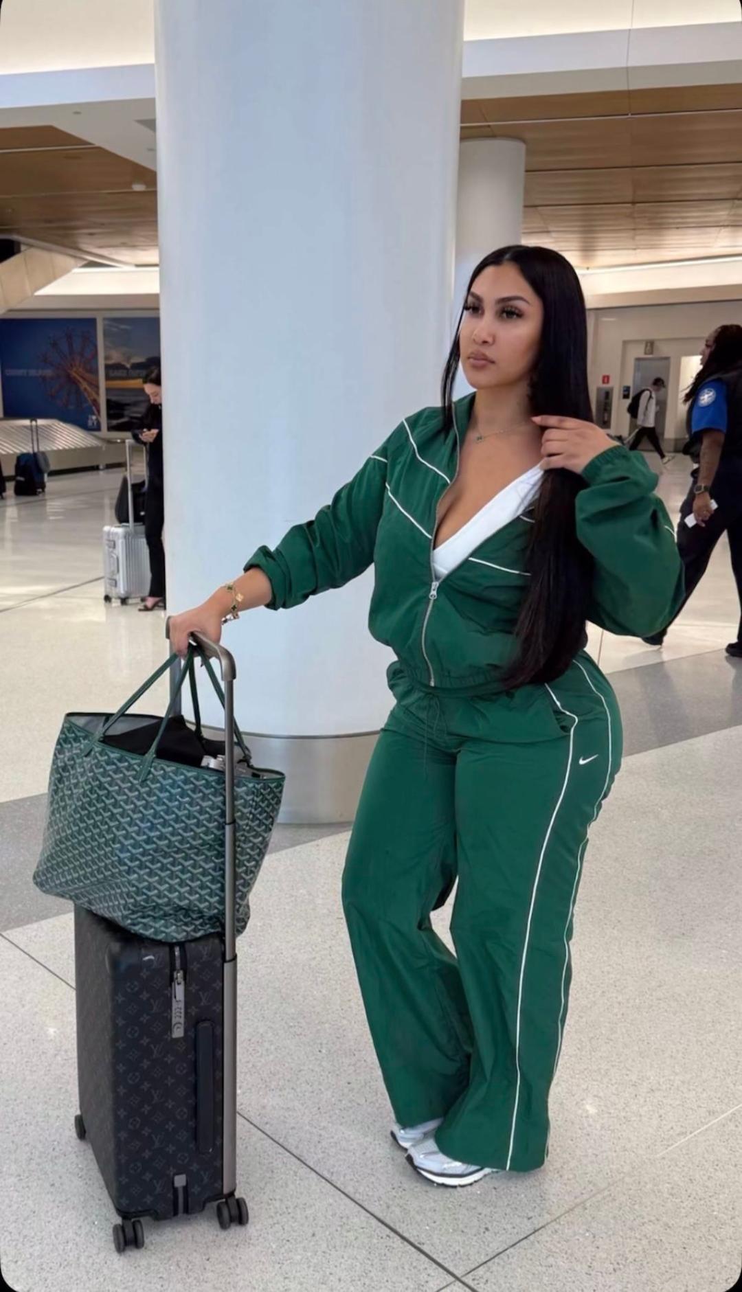 white tank top with green zip-up track jacket and matching track pants