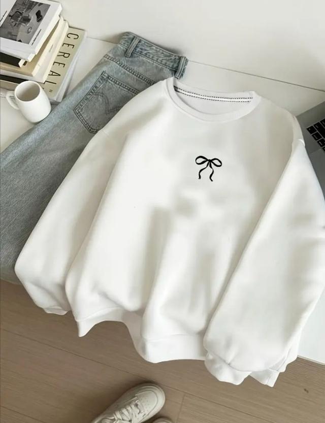 white oversized cotton sweatshirt with small black bow embroidery
