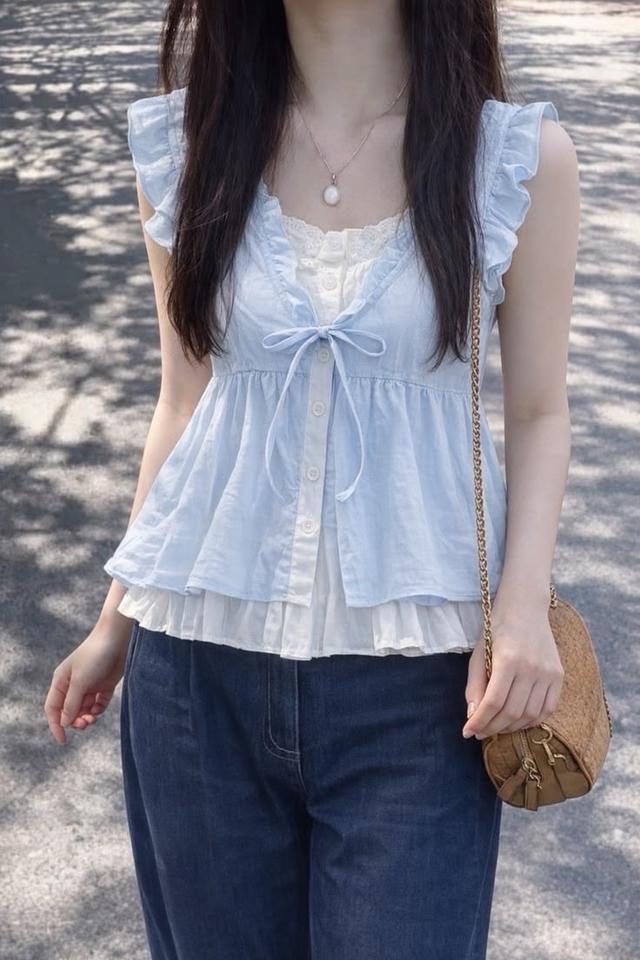 light blue ruffled cotton button-up blouse