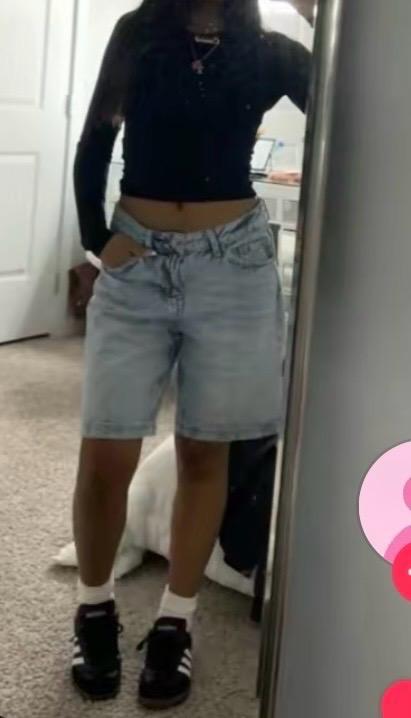 black long-sleeve crop top with light wash denim shorts