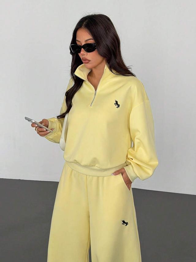 yellow half-zip sweatshirt with matching straight leg sweatpants