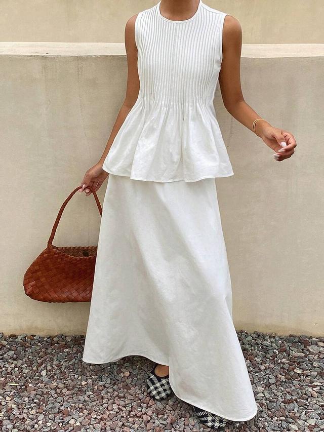 white sleeveless pleated peplum top and maxi skirt set