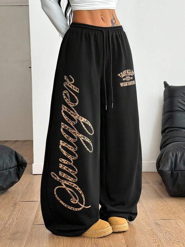 black loose wide leg sweatpants with leopard print graphic