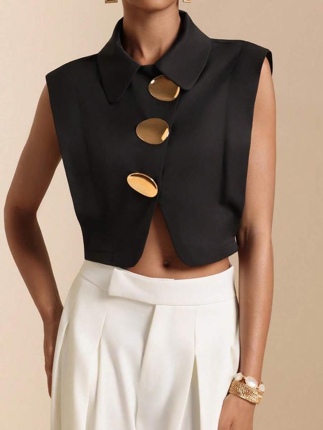 black sleeveless cropped shirt with oversized metal buttons