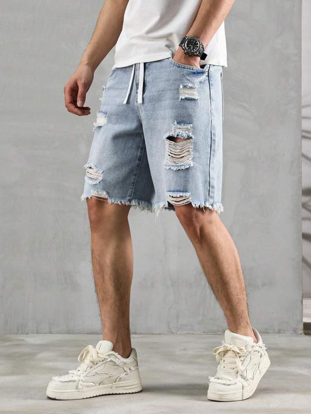 distressed light wash denim jorts with raw hem