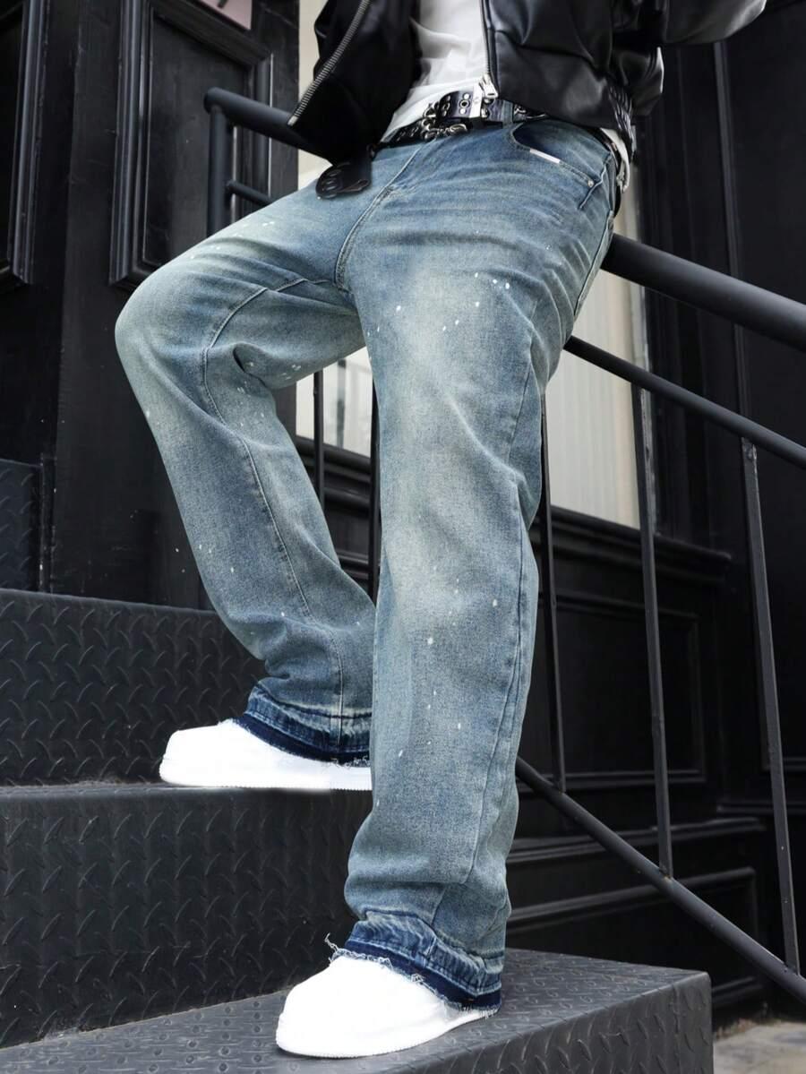 distressed washed denim flared jeans with paint splatter