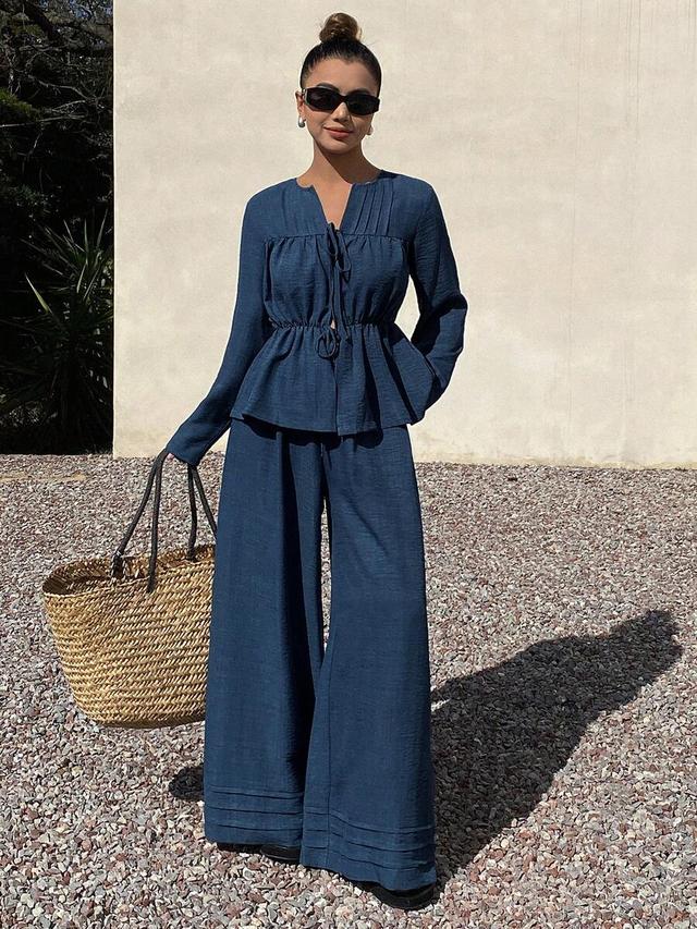navy blue pleated cinched waist top and wide-leg trousers