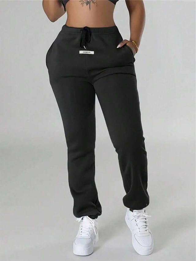 black casual drawstring waist sweatpants with decorative label