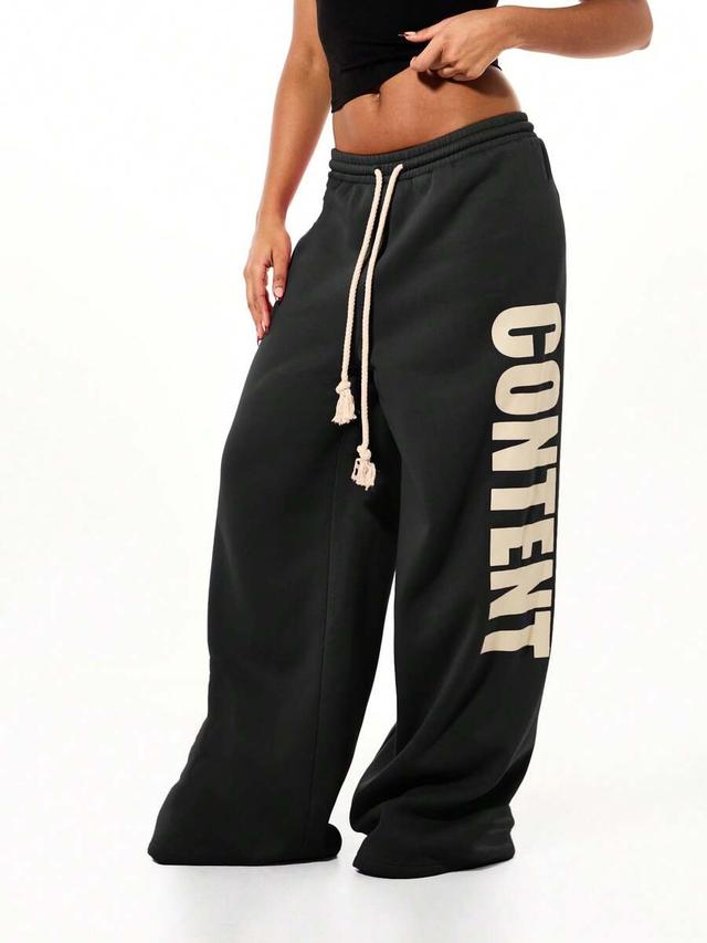 oversized black wide leg joggers with side text graphics