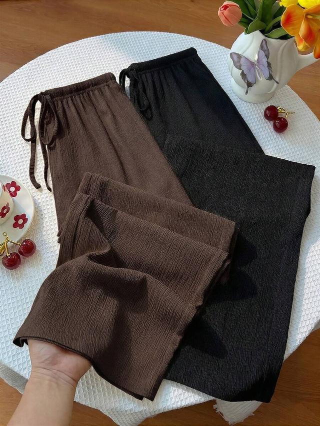 black two pairs of textured wide leg trousers in black and brown