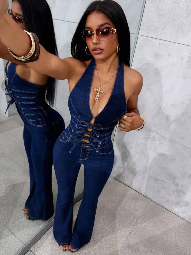 dark wash denim halter jumpsuit with lace-up front