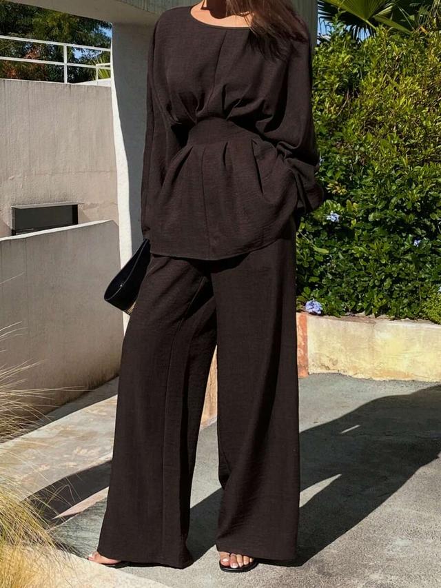 dark brown pleated waist blouse and straight leg trousers