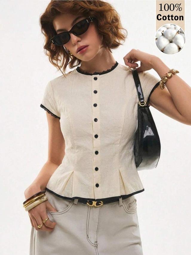 cream cotton cap sleeve blouse with black piping