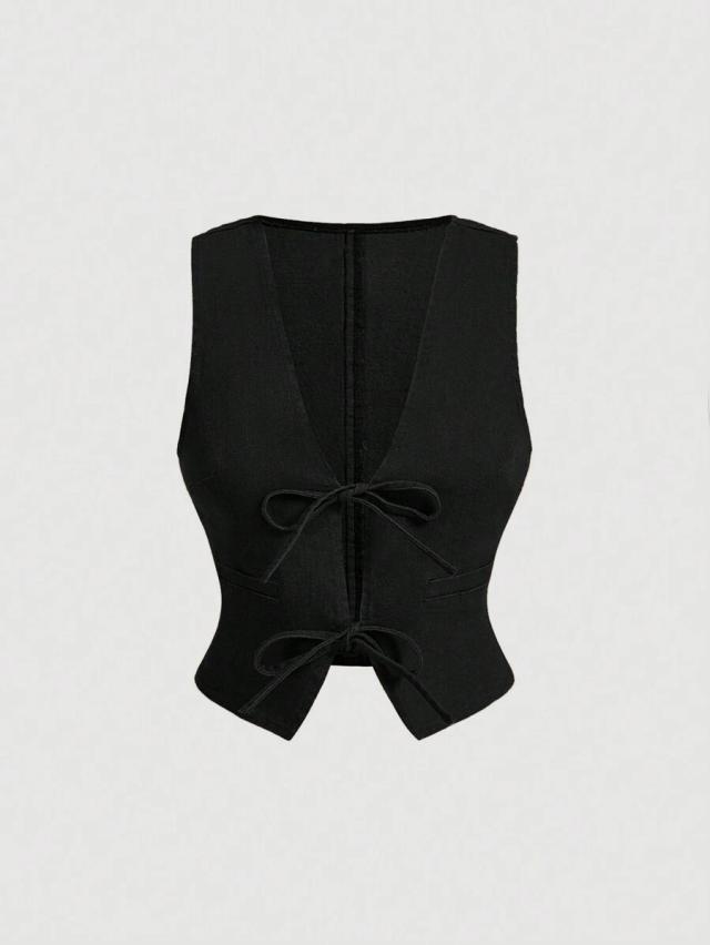 black sleeveless tailored vest with tie-front detail