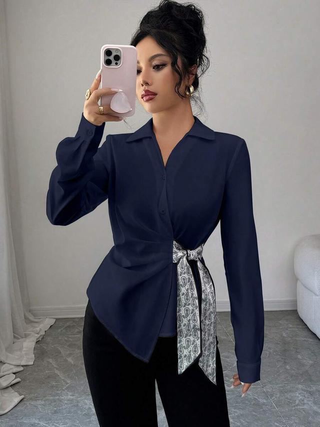 navy blue woven blouse with knot detail and collar