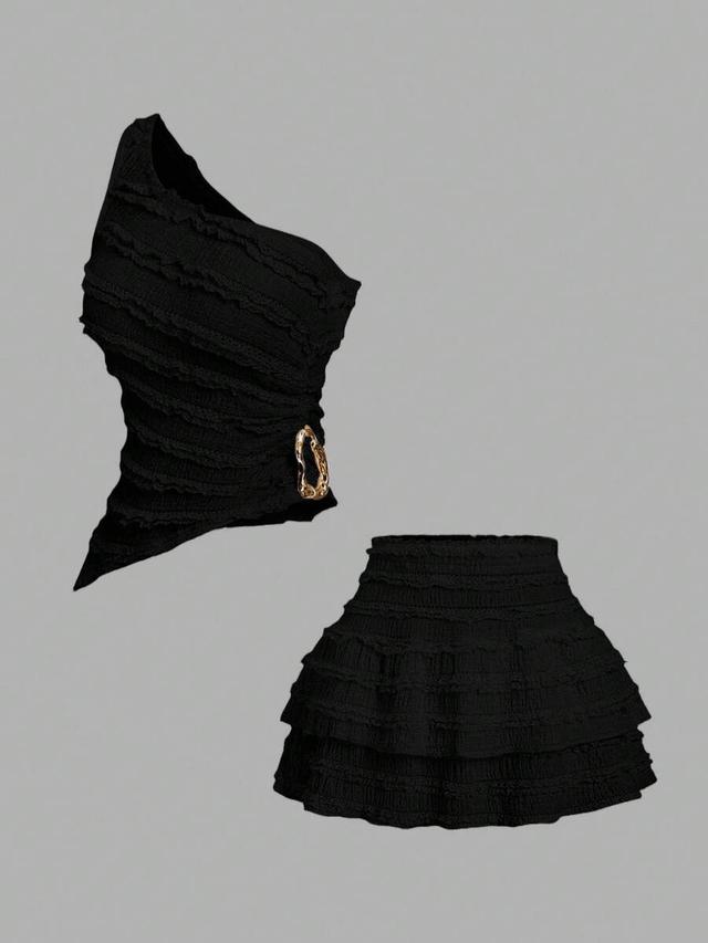 black asymmetric neck top and peplum mini skirt