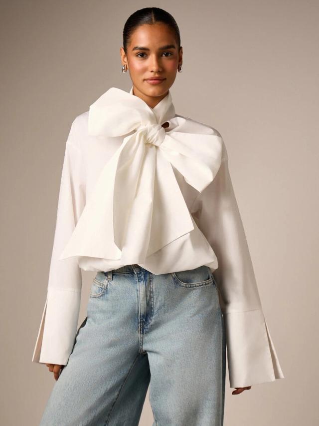 elegant white oversized bow detail blouse with bell sleeves