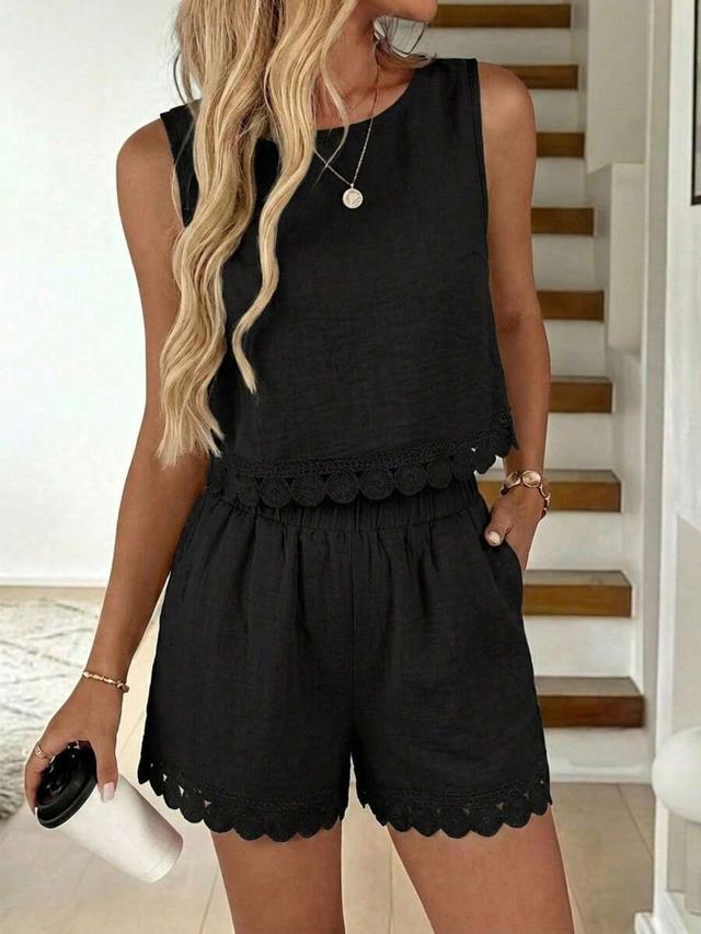 black sleeveless top with matching scalloped hem shorts