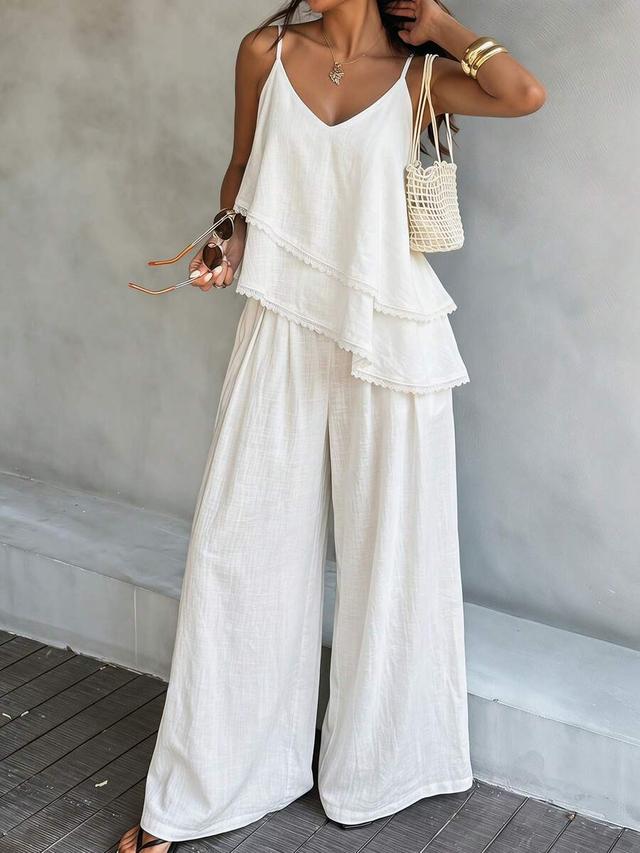 white ruffled camisole top and loose solid trousers set