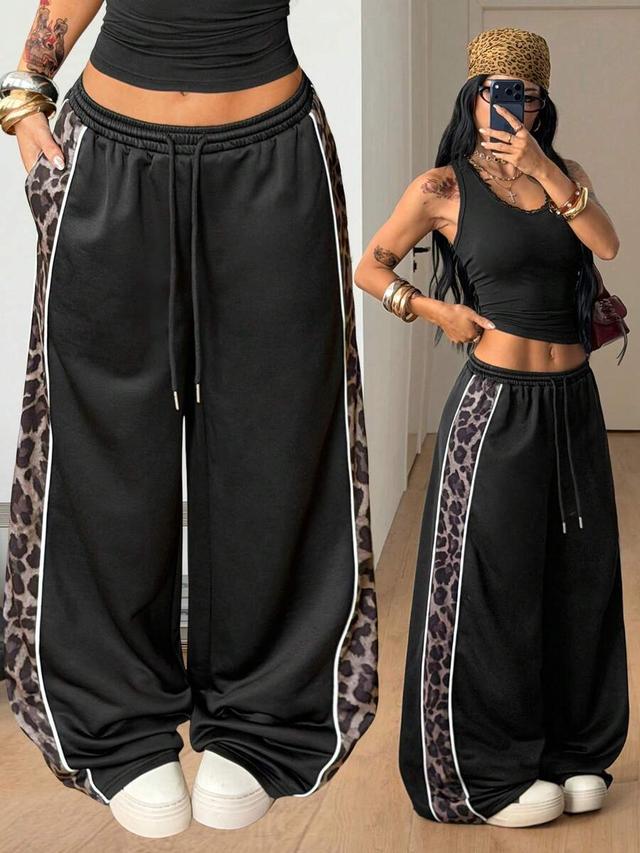 black baggy sweatpants with leopard side stripe detail