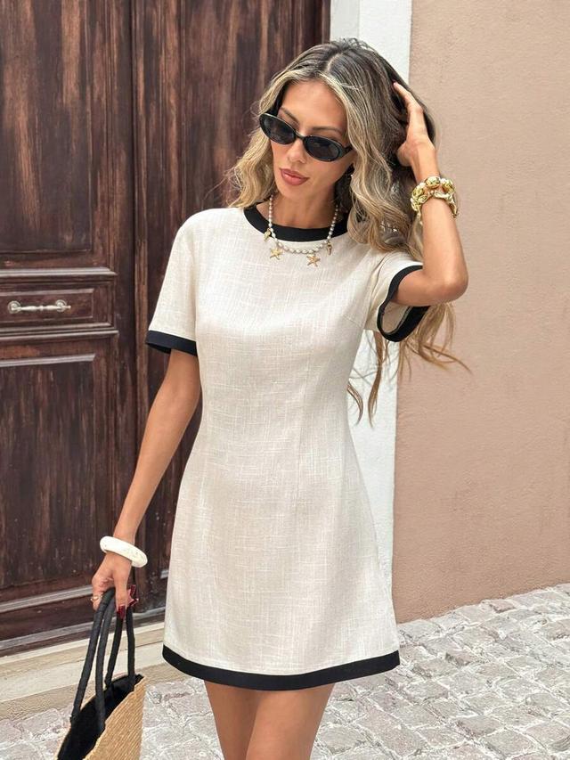 beige linen shift dress with black contrast trim