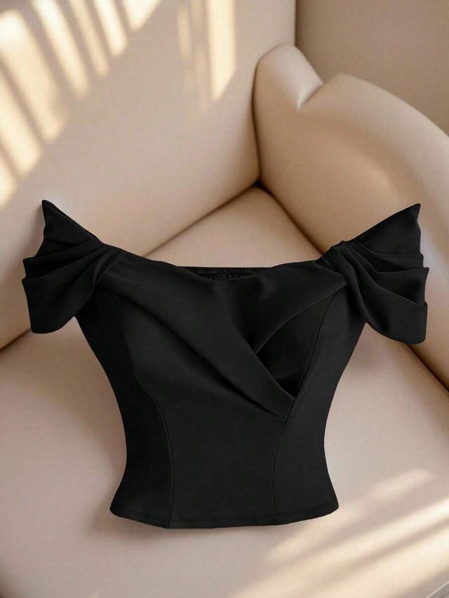 elegant black off-shoulder cropped top with pleated design