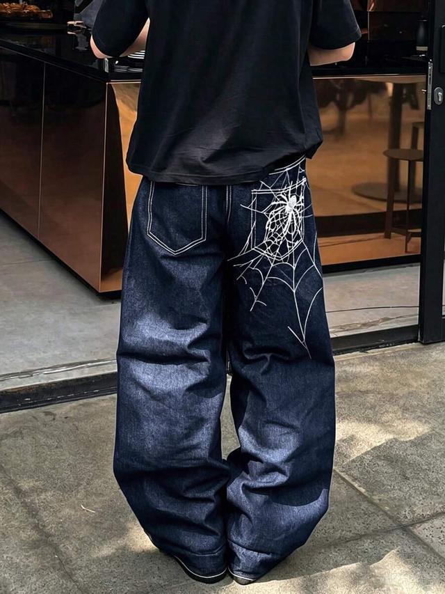 dark wash denim jeans with spider web embroidery