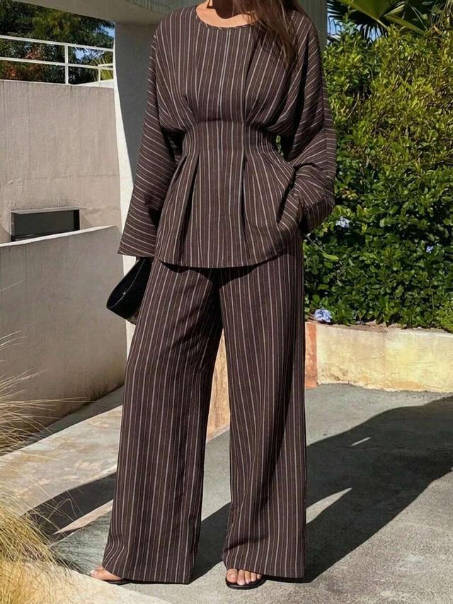 brown striped waist-cinched blouse and straight leg trousers