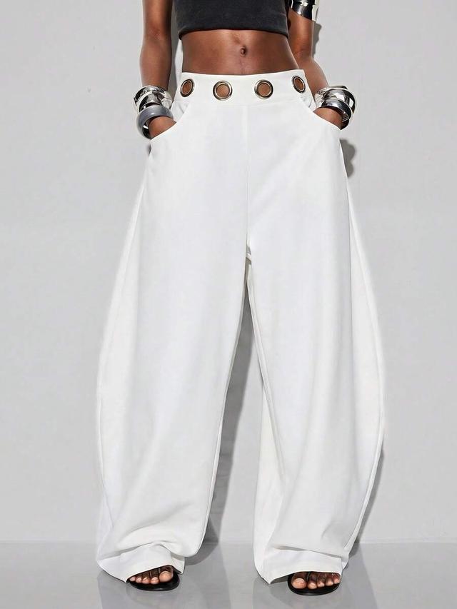 white oversized flared harem pants with metallic eyelet waistband