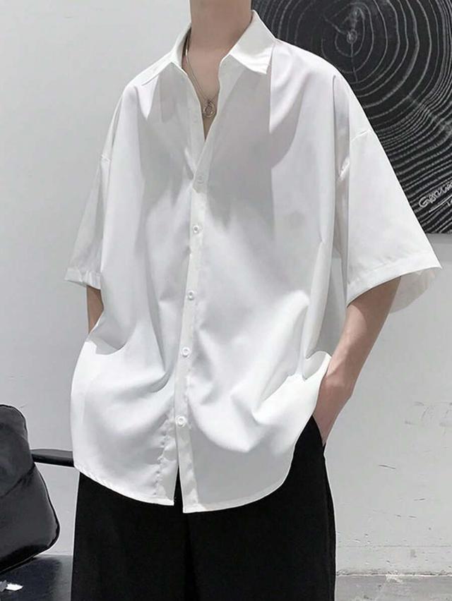 white oversized short sleeve button-down shirt