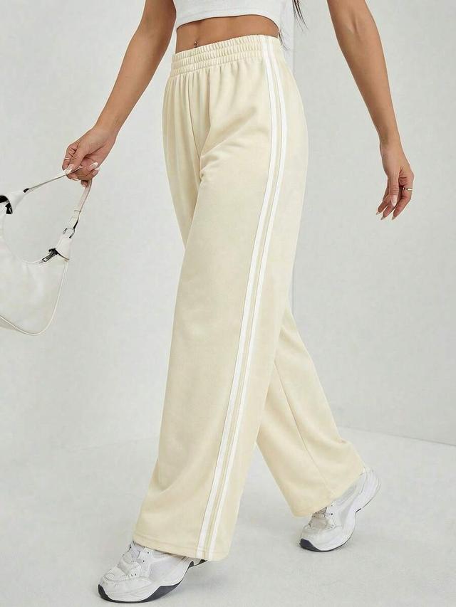 beige casual sports pants with striped side seam