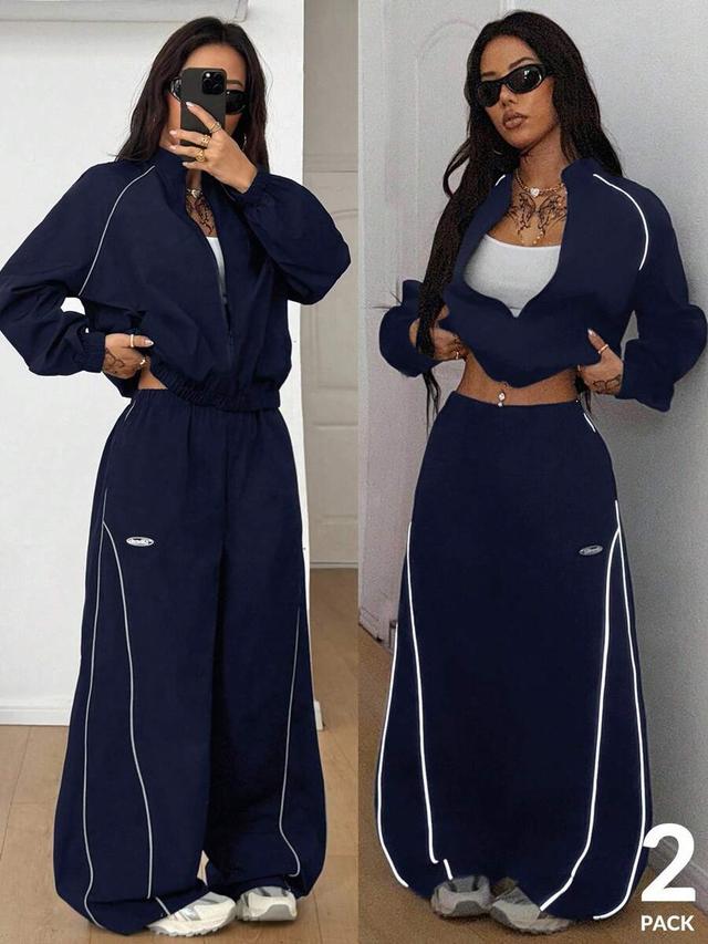 navy blue reflective zip-up jacket and parachute pants