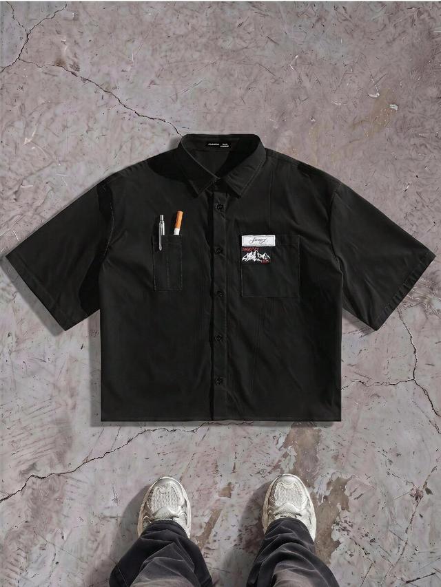 black short sleeve shirt with chest pocket and patch