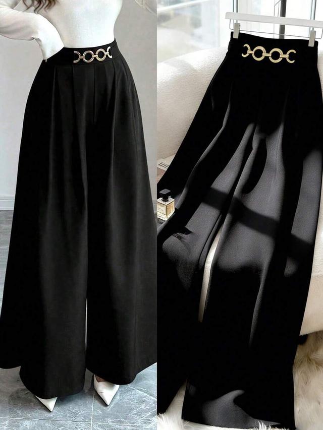 high waist black flared leg trousers with metal detail