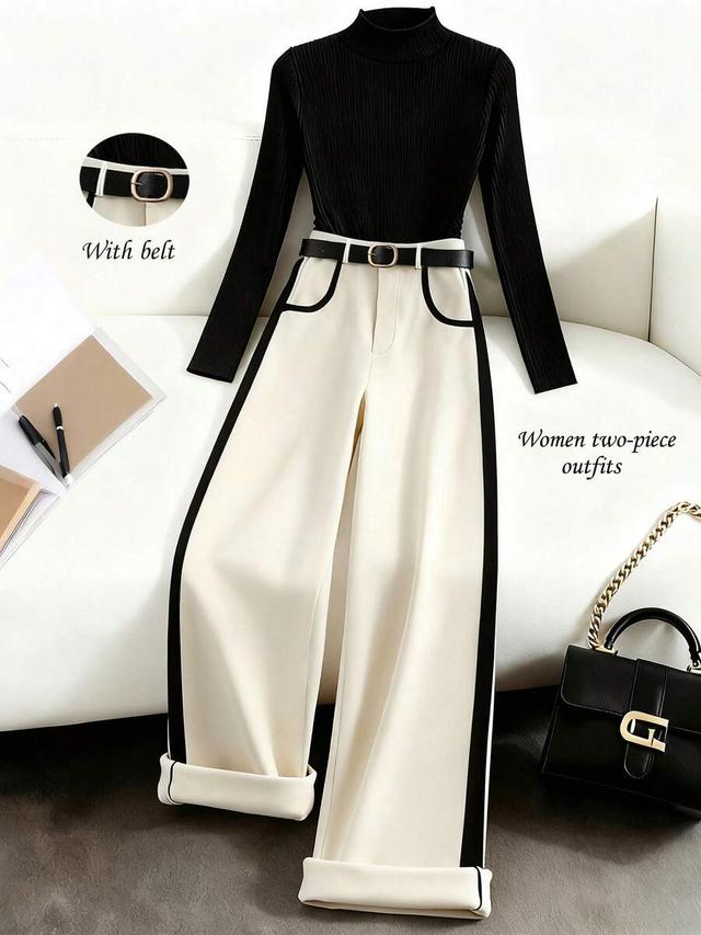 black knit long-sleeved top with beige wide-leg trousers
