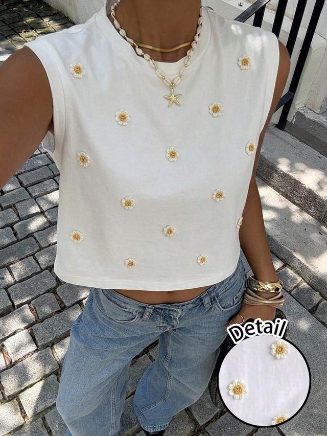 white sleeveless cropped tank with daisy embroidery