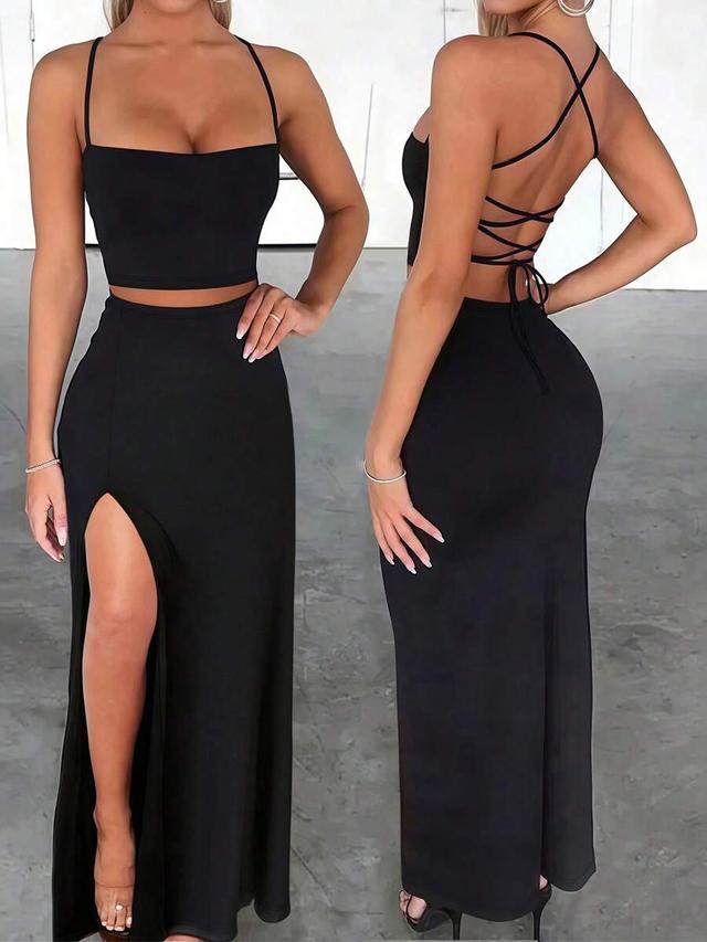 black fitted criss-cross camisole and high slit skirt